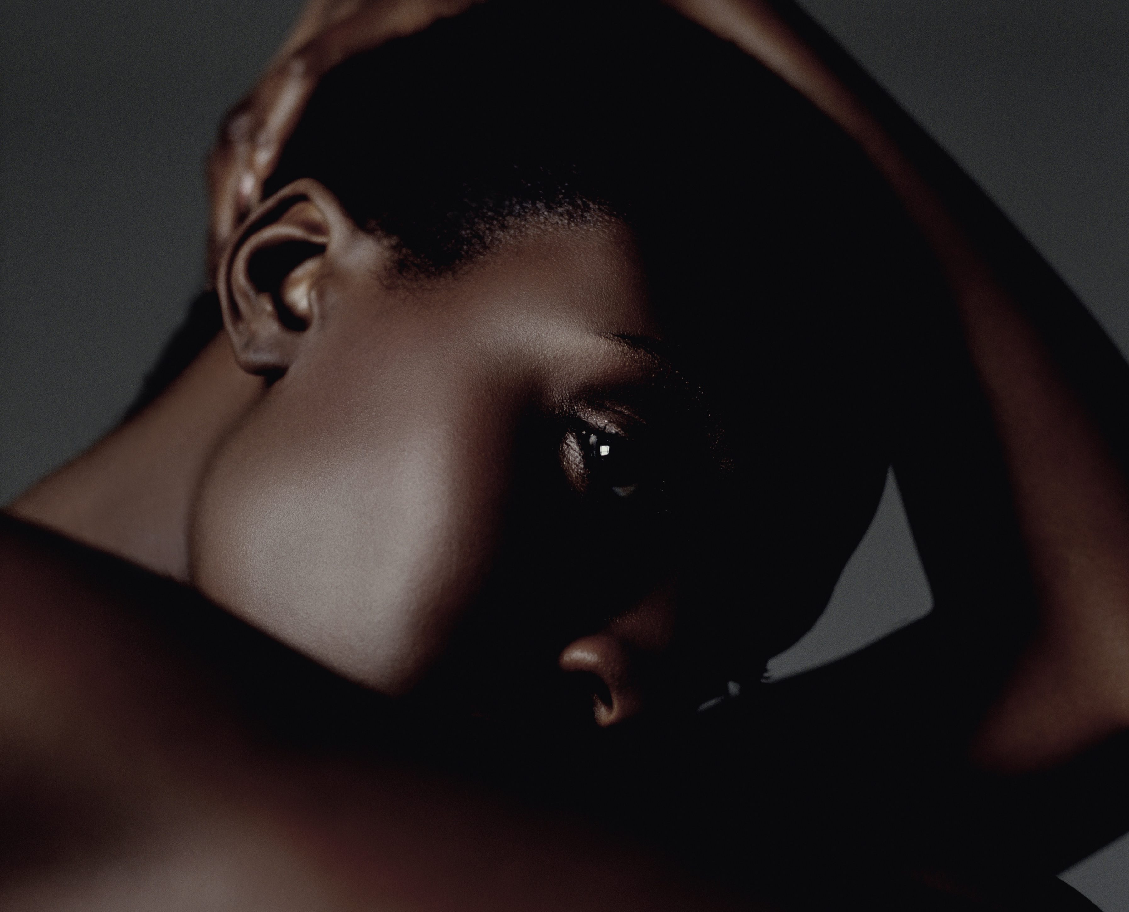 Woman Sits Holding Head