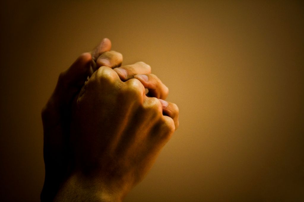 Close-up of a man's hand praying