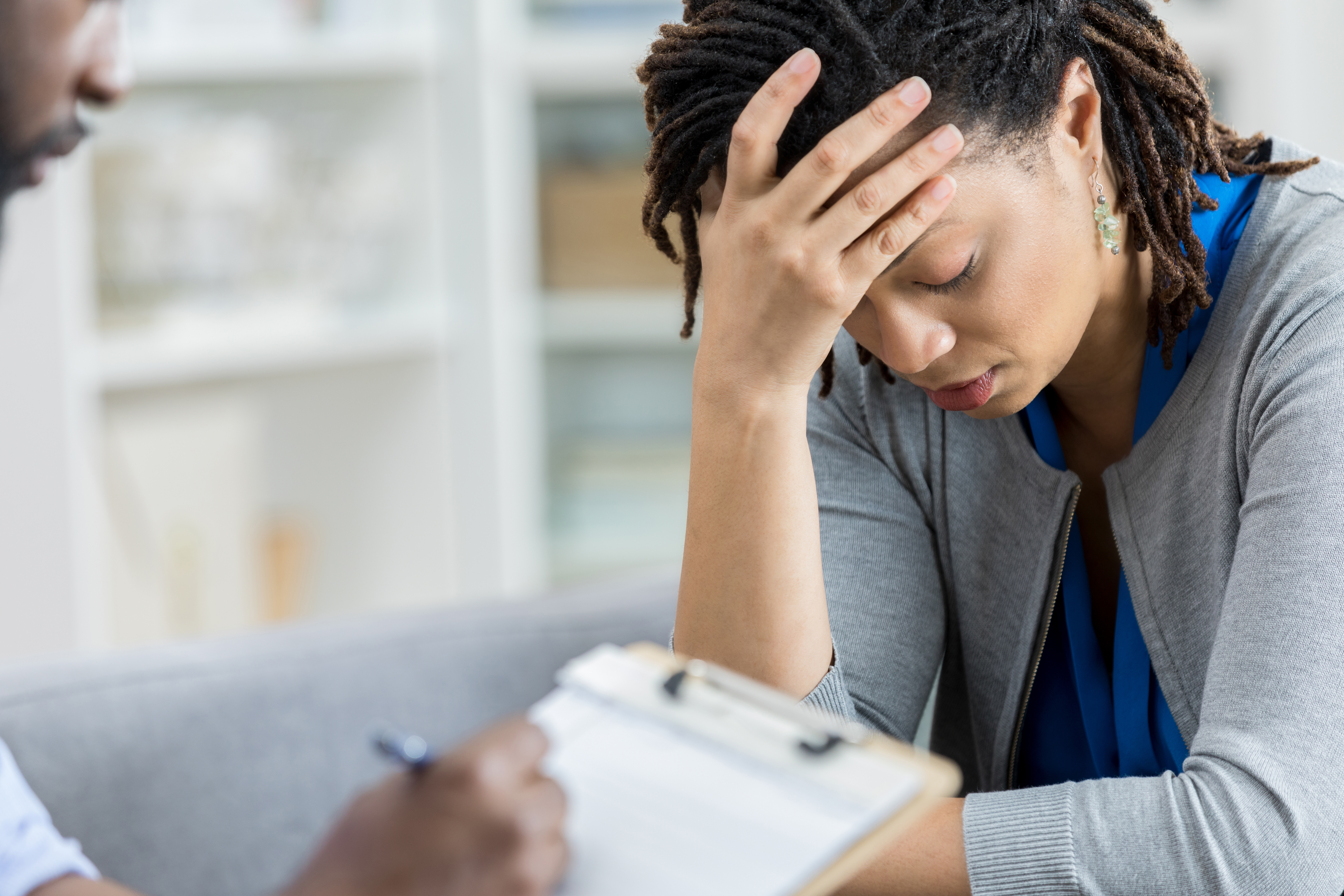 Counselor talks with depressed woman