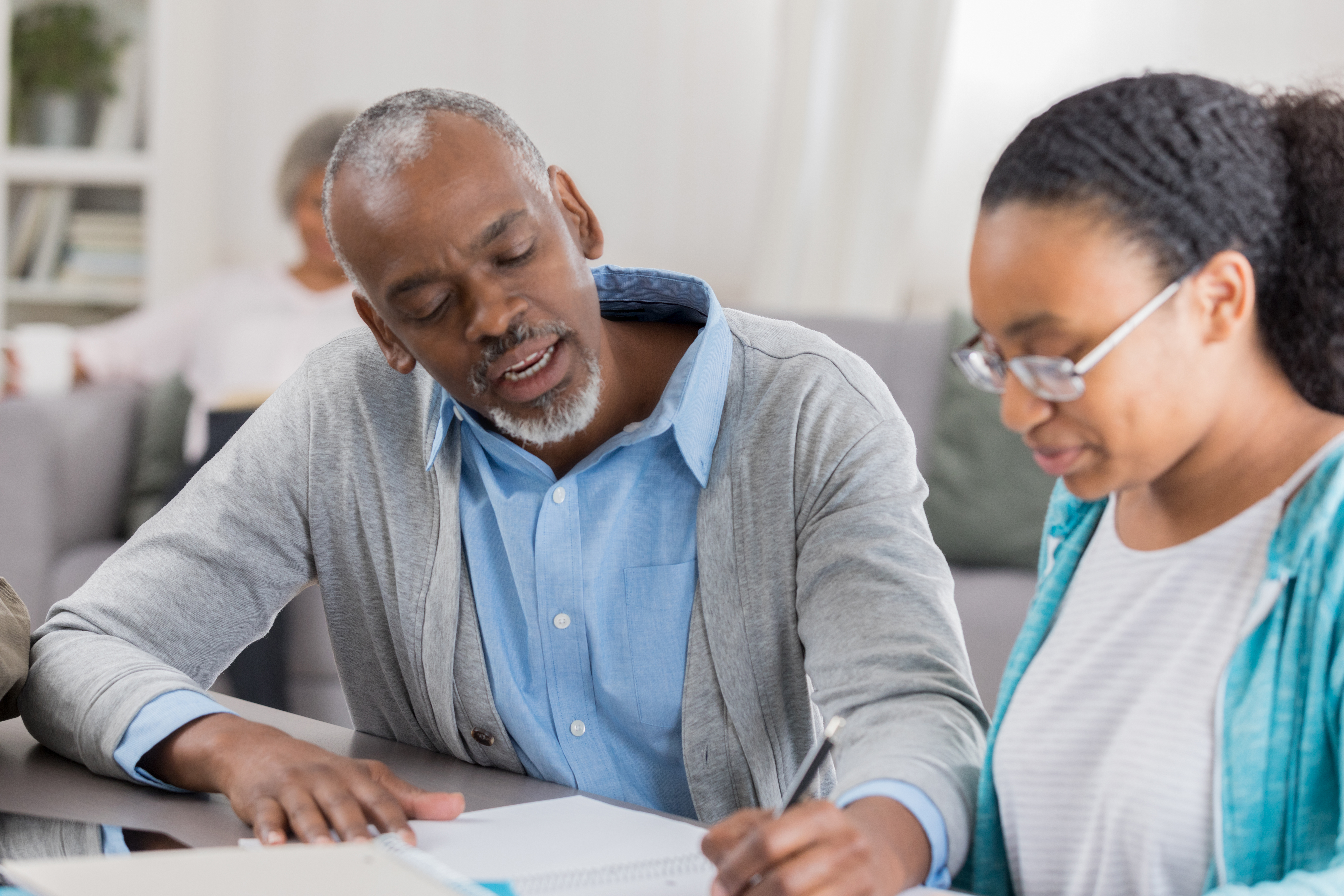 Granddad helps granddaughter with homework