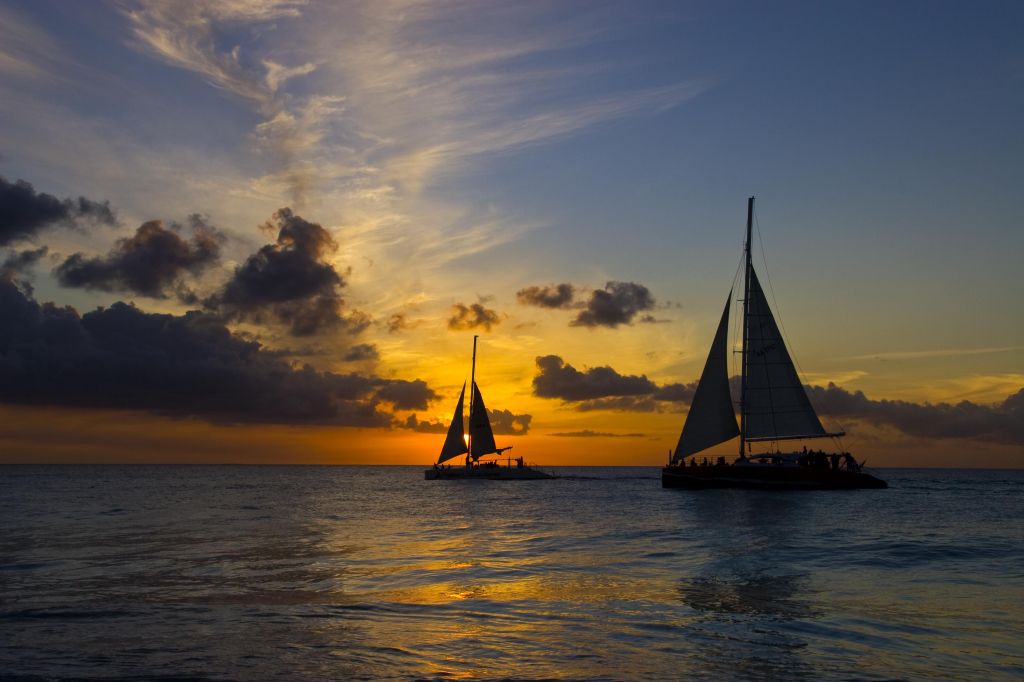 Silhouette of Two Sailboats on Ocean at Sunset