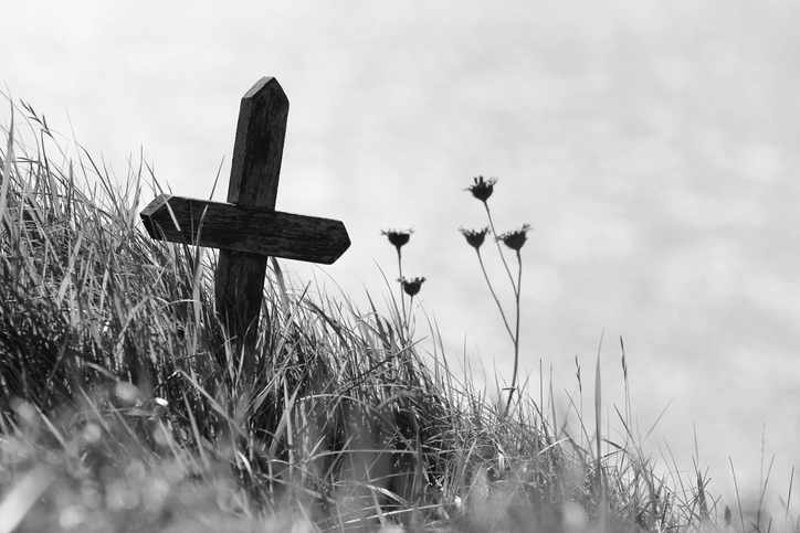 Wooden cross on the edge of a cliff