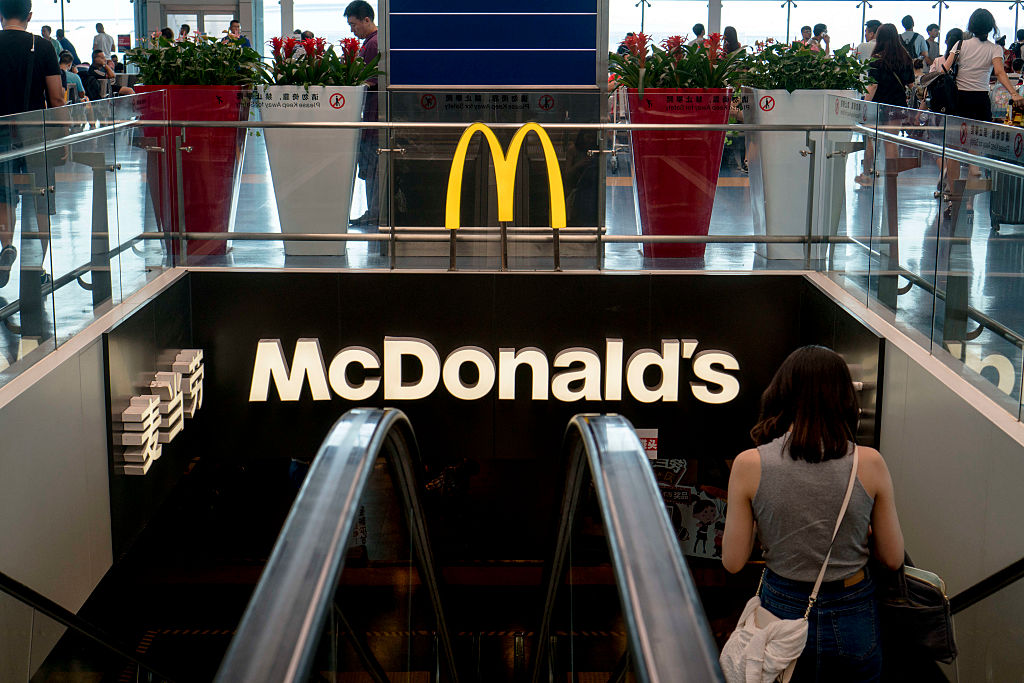 A girl walks into a McDonald's restaurant in airport...