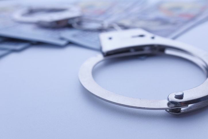 handcuff and cash