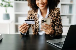 Business woman hands holding credit card with digital layer effect diagram as Online shopping concept