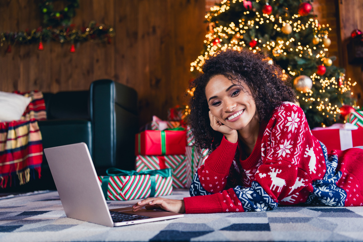 Photo of cute lovely girl lying on fluffy carpet red ornament pullover spending weekend alone in decorated cozy home room indoors